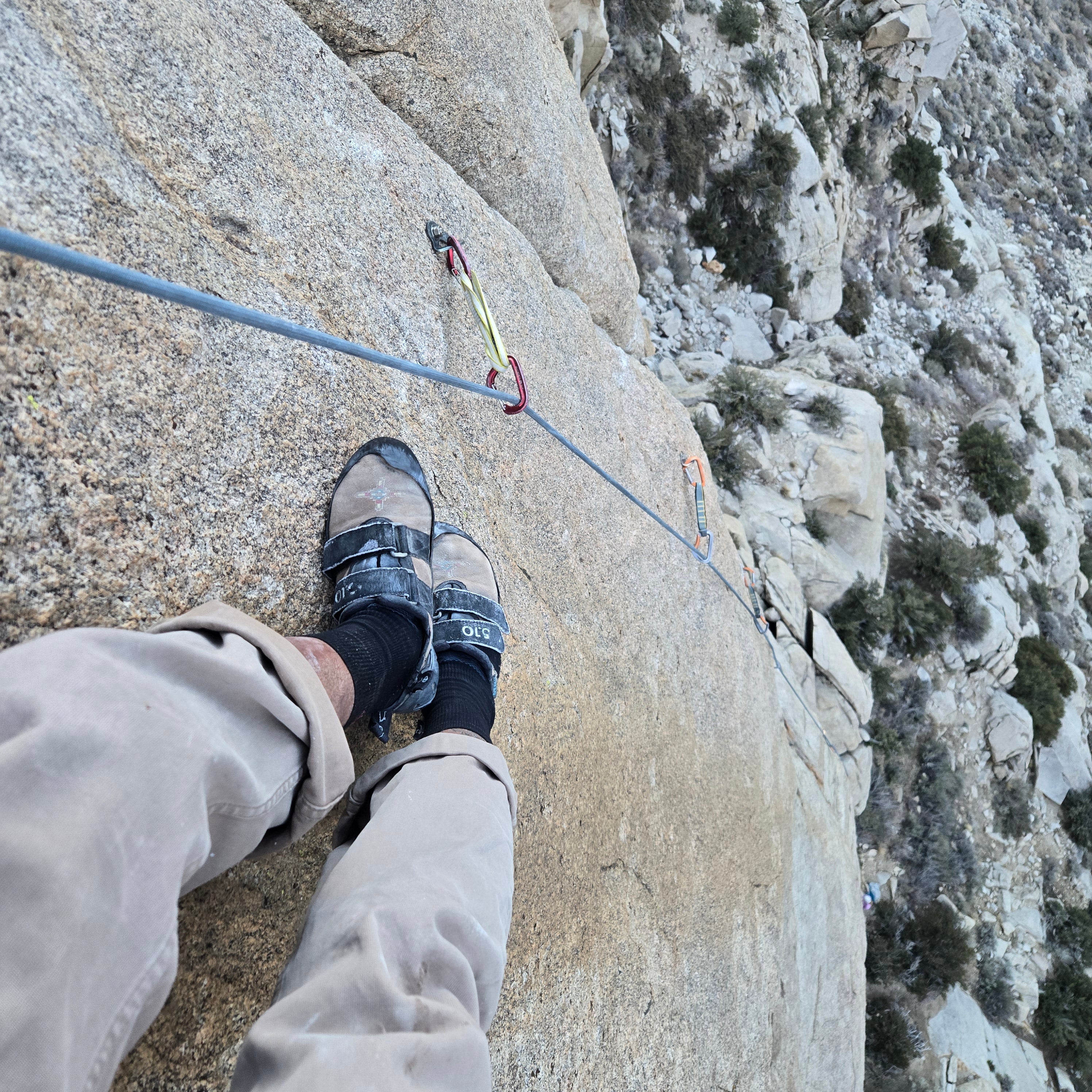 GraceWul rock climbing socks in tight shoes on climbing route
